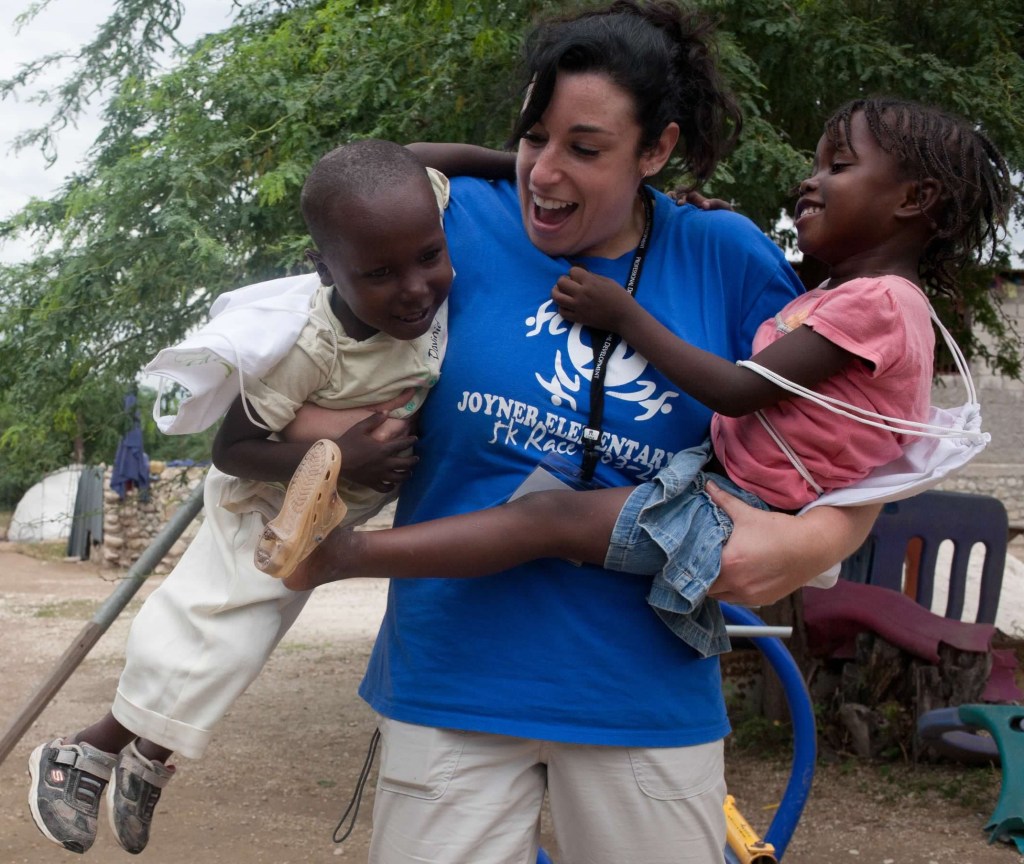 Jen swinging 2 kids around, playing