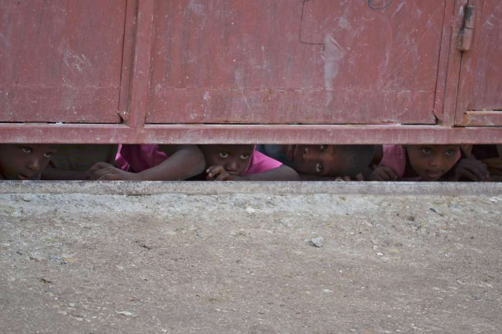 Kids peeking under gate as we approached