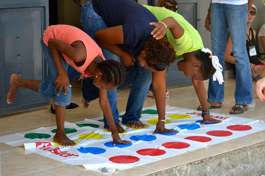 Kids playing Twister on orphanage steps