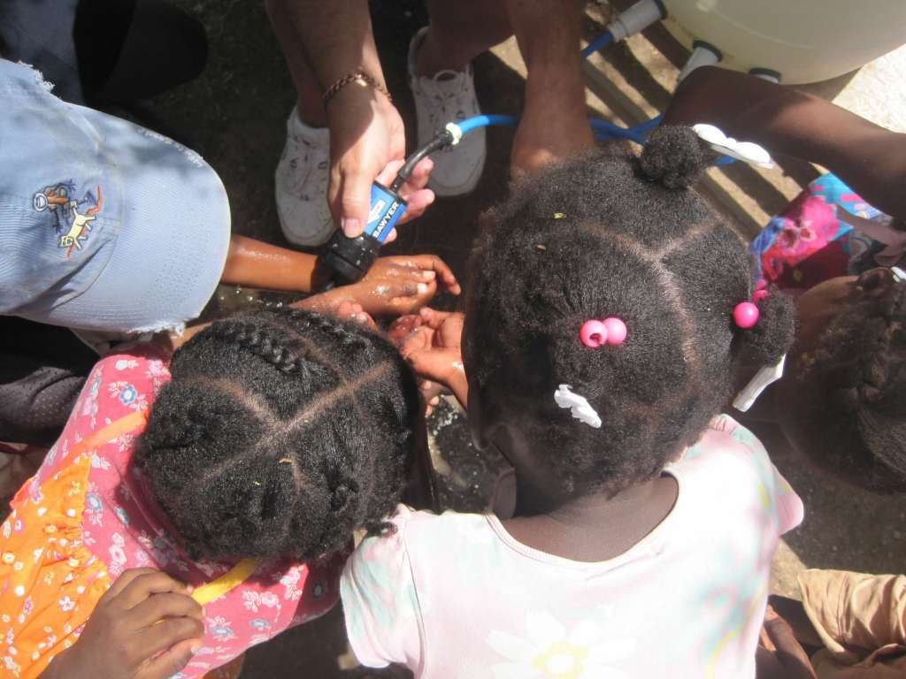 Children washing their hands with filtered water.